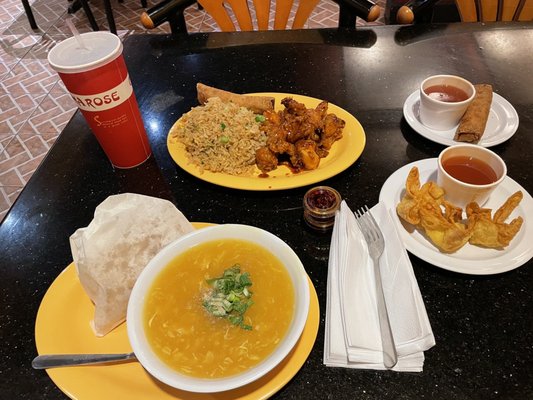 Egg drop soup, crab Rangoon, egg roll, orange chicken meal