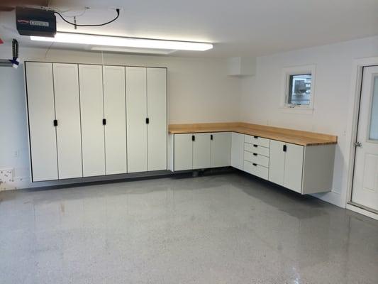 Beautiful white powder-coated cabinets with butcher block maple counter top.