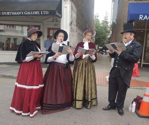 Carolers! They make their way up and down the street during December.