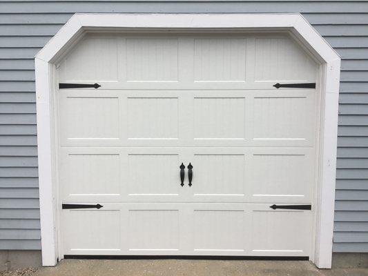 Short grooved panel steel door with decorative hardware in Falmouth