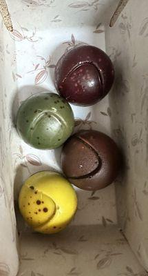 Canonica bonbons top to bottom -- raspberry, earl grey, something with rosemary (lemon maybe), creamy passion fruit.