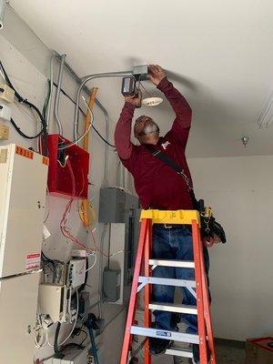 Technician in action installing a smoke detector