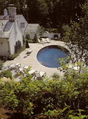 Multiple Natural Stone set in cement for a pool deck with curved stone coping.