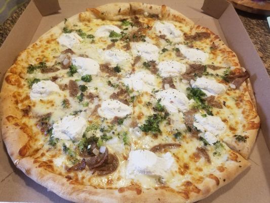 White pizza from Two Guys,  with Ricotta,  Broccoli, Onion and Italian sausage. Tasted as good as it looks