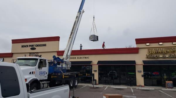 Crane lift with new AC system for Bosco Custom Home Builders.  If you need a custom home built Bosco is the team to call.