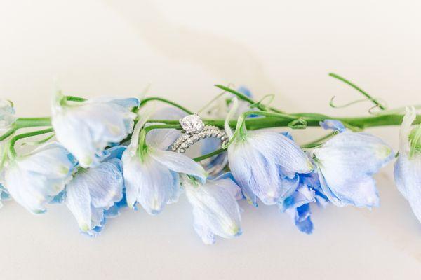 Close up of wedding rings with flowers