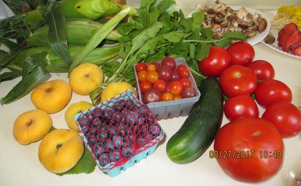 Corn, arugula, tomatoes, mushrooms, cucumber, blueberries, and donut peaches.