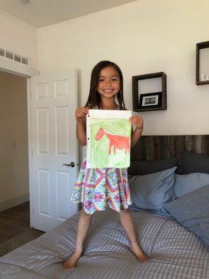 A proud artist shows off her work after her virtual horse life-drawing class where we went to visit the horse sanctuary!