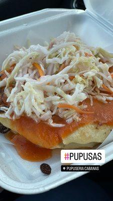 Pupusas properly dressed with tomato sauce and Curtido