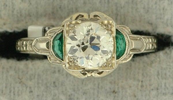 18k white gold Art Deco 0.92ct diamond ring with synthetic emerald side stones.