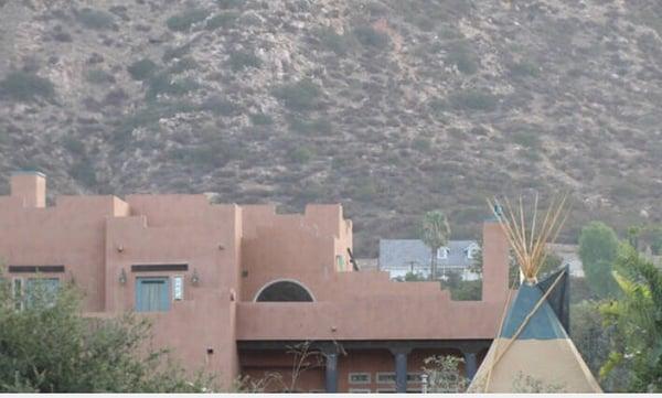 Tipi with our pueblo style home in background