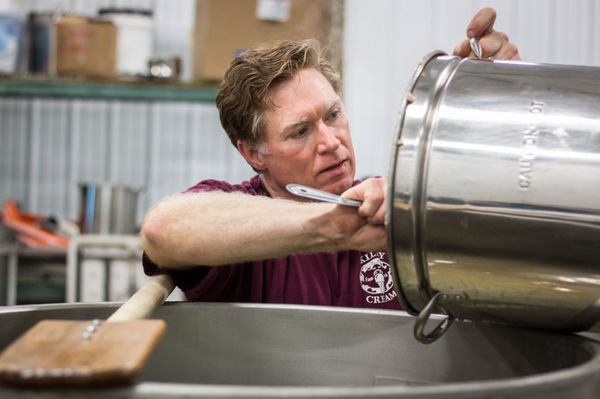 Scraping out the oatmeal into the mash