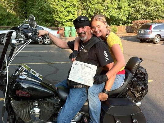 A biker couple, posing on their Harley.