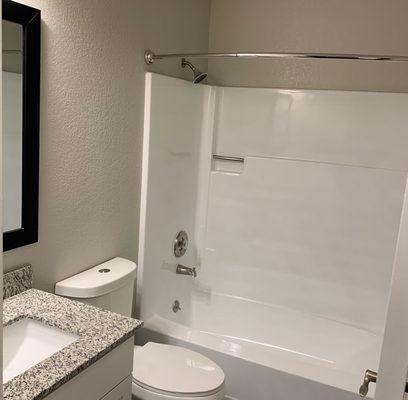 Remodeled unit with freshly refurbished tub enclosure.