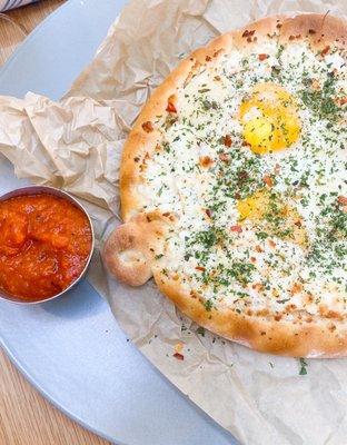 Khachapuri (cheesy flatbread) ; sunny side up eggs; mozarella; shakshuka sauce