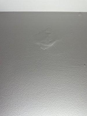 Clump of spackle painted over. When pointed out it was ignored.