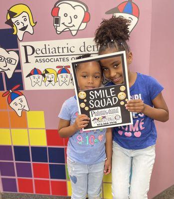 Two sisters showing off their beautiful smiles.