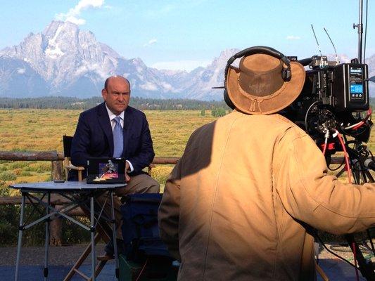 working for CNBC with the Tetons as a backdrop