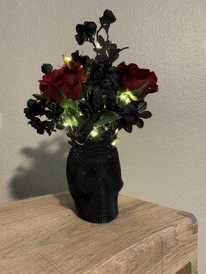 Black 3D printed skull, with missing skull cap for the flowers and lights.