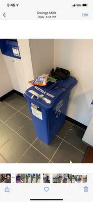 Overflowing recycling bin with trash on top!