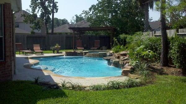 Custom gunite pool with weeping wall and spa/hot tub.  Also added a outdoor Pergola and landscaping.