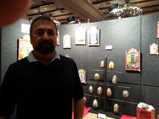 Santero Ruben Gallegos in front of his artwork.