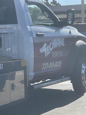 the logo on the flatbed tow truck