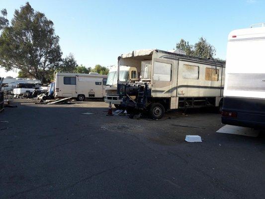 RV Storage is in a junkyard, on a dirt lot. Wind blows dirt and junk onto your RV.