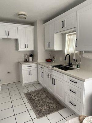 Satin white cabinets with Black Handles and 30" kitchen sink.