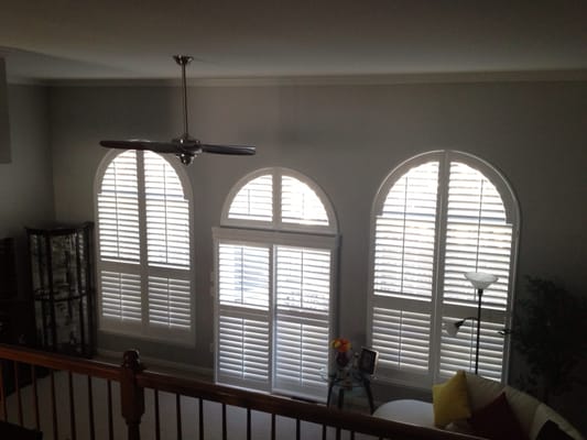 Here is an example of arch top shutters and a bypass shutter on sliding glass door in a Leesburg Virginia home.