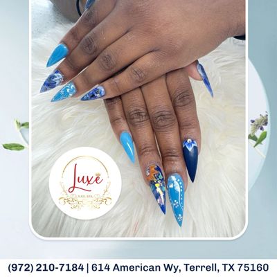 Elevate your style with our stunning blue floral nails!  Perfect for any occasion. Book your appointment today!