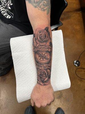 Tattoo of my kids name with roses and a compess