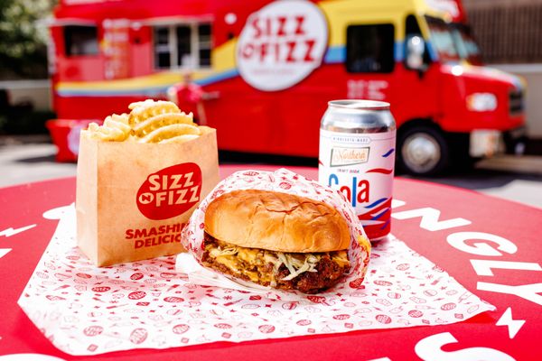 Sizz Burger - Our signature double patty smash burger with sizzy sauce, American cheese, griddled onions, shaved lettuce on a Hawaiian bun