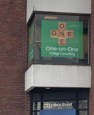 One-on-One College Consulting's kelly green logo is prominently displayed in second floor office window.