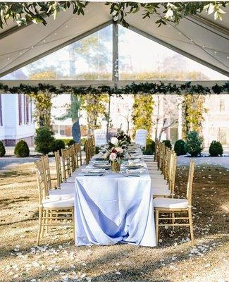 Gold Chiavari Chairs, Periwinkle Linen under a 20'x Frame tent with clear gables.