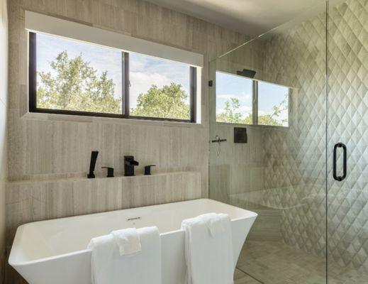 Soaking tub and separate large shower with pillow-edged tiles