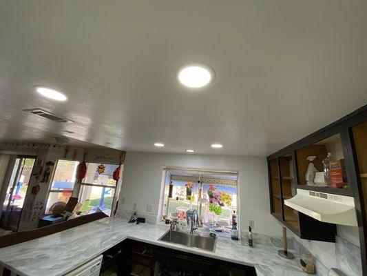 We lit this kitchen up with some recessed dimmable lighting .