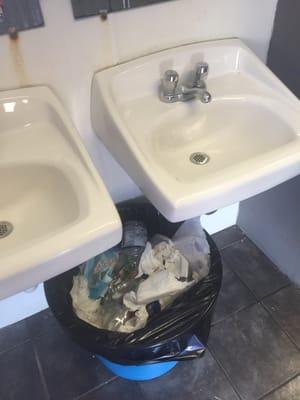 Disgusting overflowing trash. I'll spare you photos of inside the I flushed toilets.