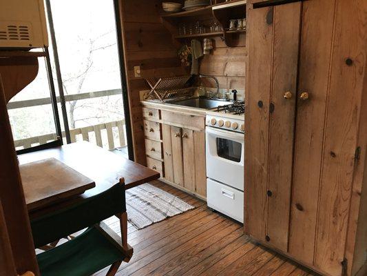 Kitchen with all appliances (refrigerator is behind the closed panels right of stove) all needed utensils provided.