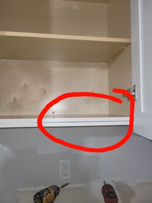 Defective door is longer than actual cabinet. Unnecessary slab on bottom of cabinet, coming apart.