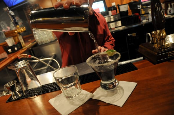 A demonstration of good shaker techniques, used to make a twist on the classic Jack and Coke.