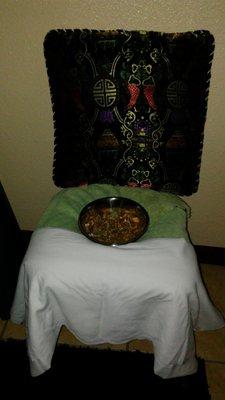 Yoni Steaming Chair with a bowl of herbs