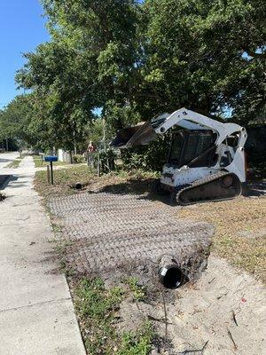 Installing culvert pipes.