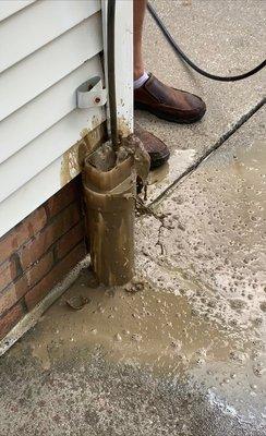 Clogged Downspout Drain causing damage to foundation