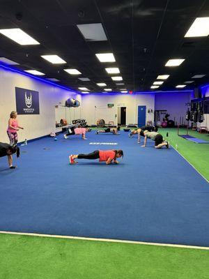 Members doing a finisher at the end of class, to get the most out of strength and HIIT Training