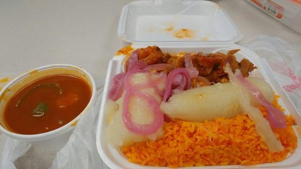 deliciously seasoned pork, yuca and onions, yellow rice and red beans.