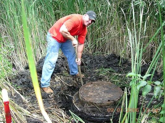 Josh digging up a manhole for repair in the City of Orono