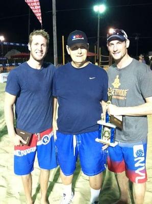 Dr. Allison with his patient / athlete receiving National Voleyball League Championship trophy