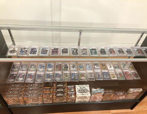 Glass display case PSA cards and hobby/retail boxes.