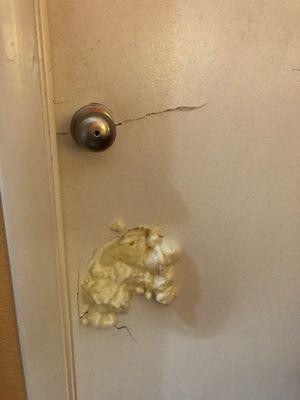 Expandable foam in bathroom door. notice the big crack too